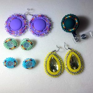 Beaded earrings and a badge reel